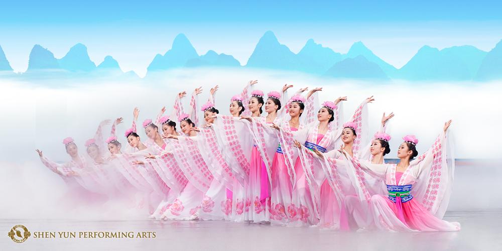 Image of traditional Chinese dancers, wearing white and pink outfits. The background features a white, cloudy scene. 