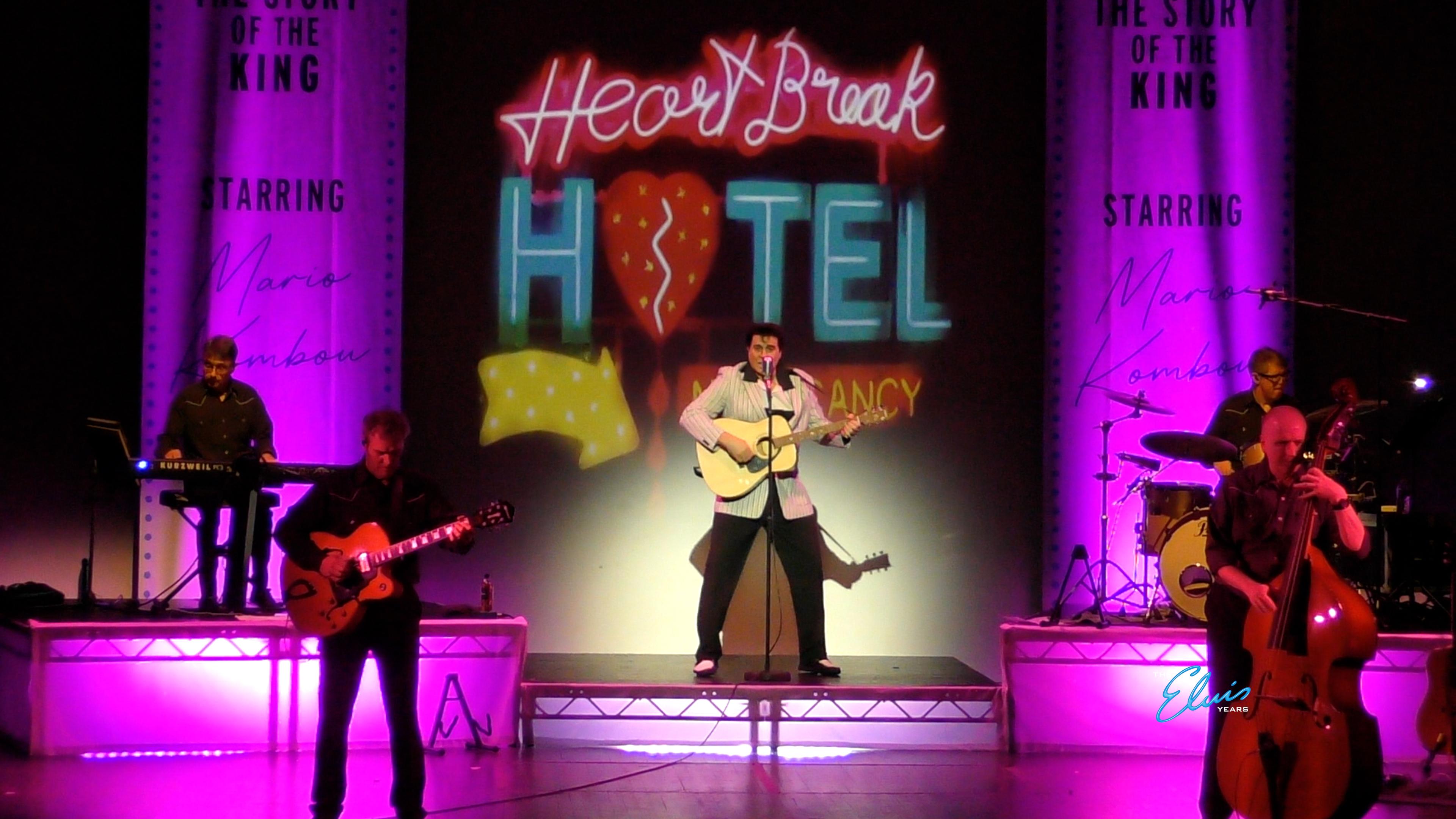 Man singing on stage and playing guitar