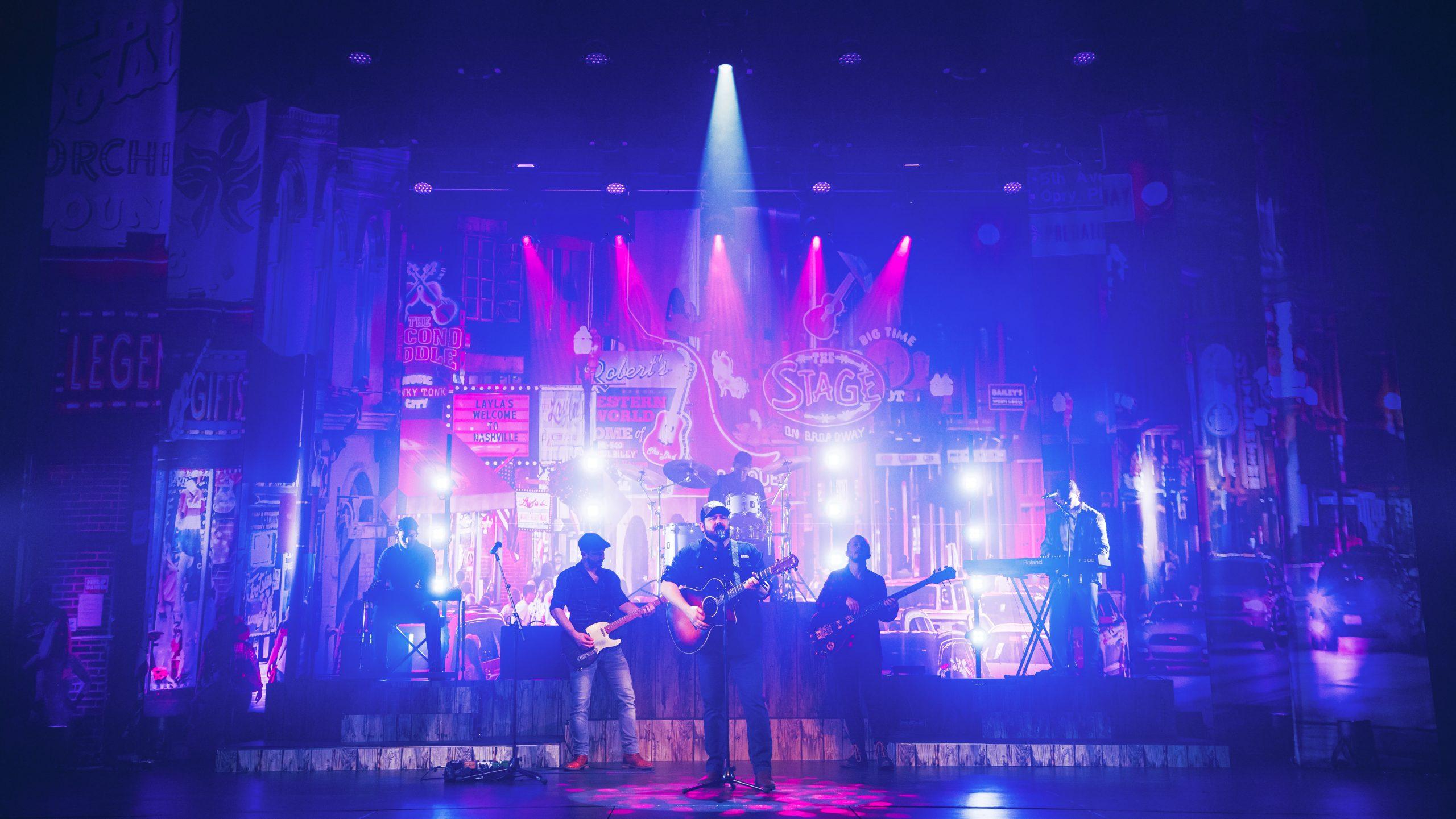 Luke Combs on stage with band