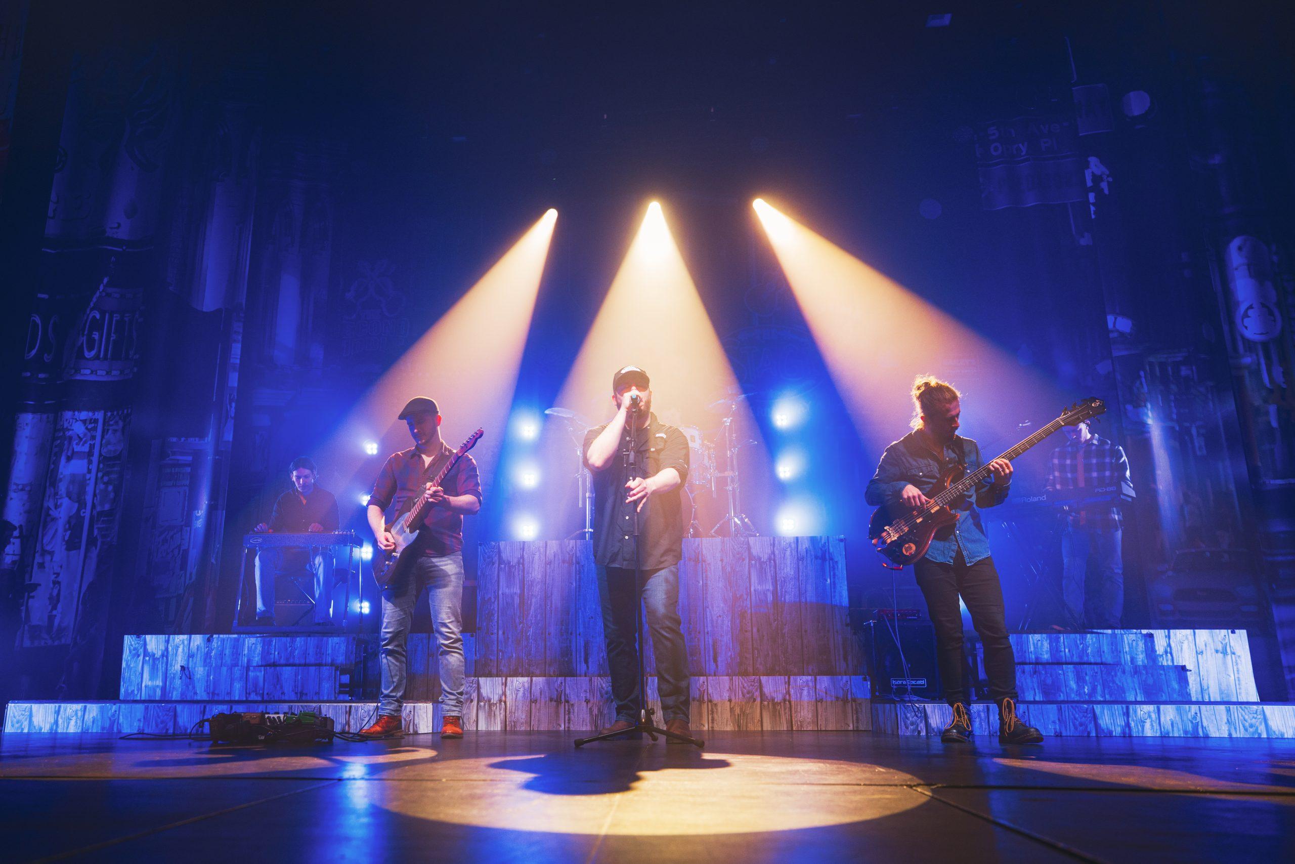 Luke Combs on stage with band