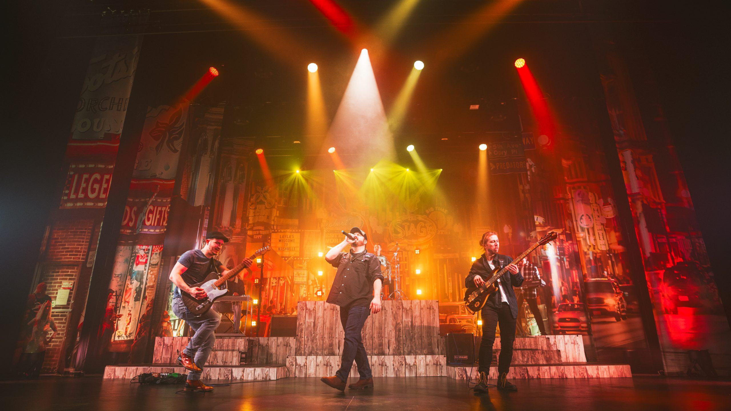 Luke Combs on stage with band