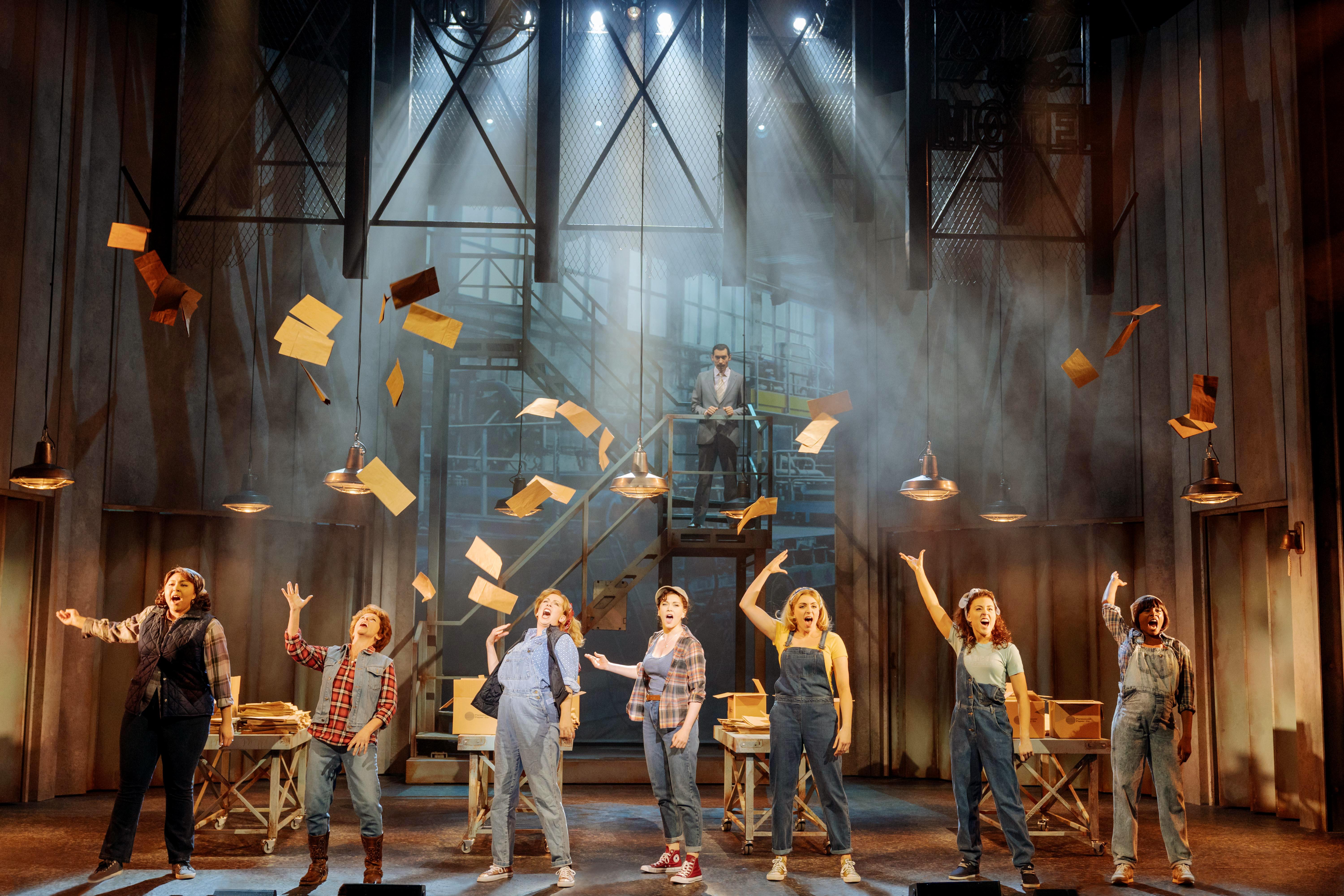 Image of seven women throwing paper in to the air