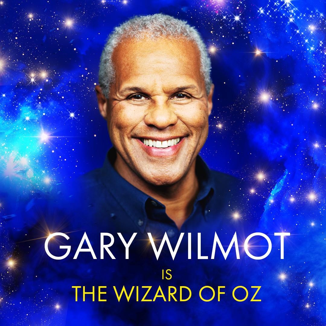 Gary Wilmot's headshot in front a dark blue, sparkly background.