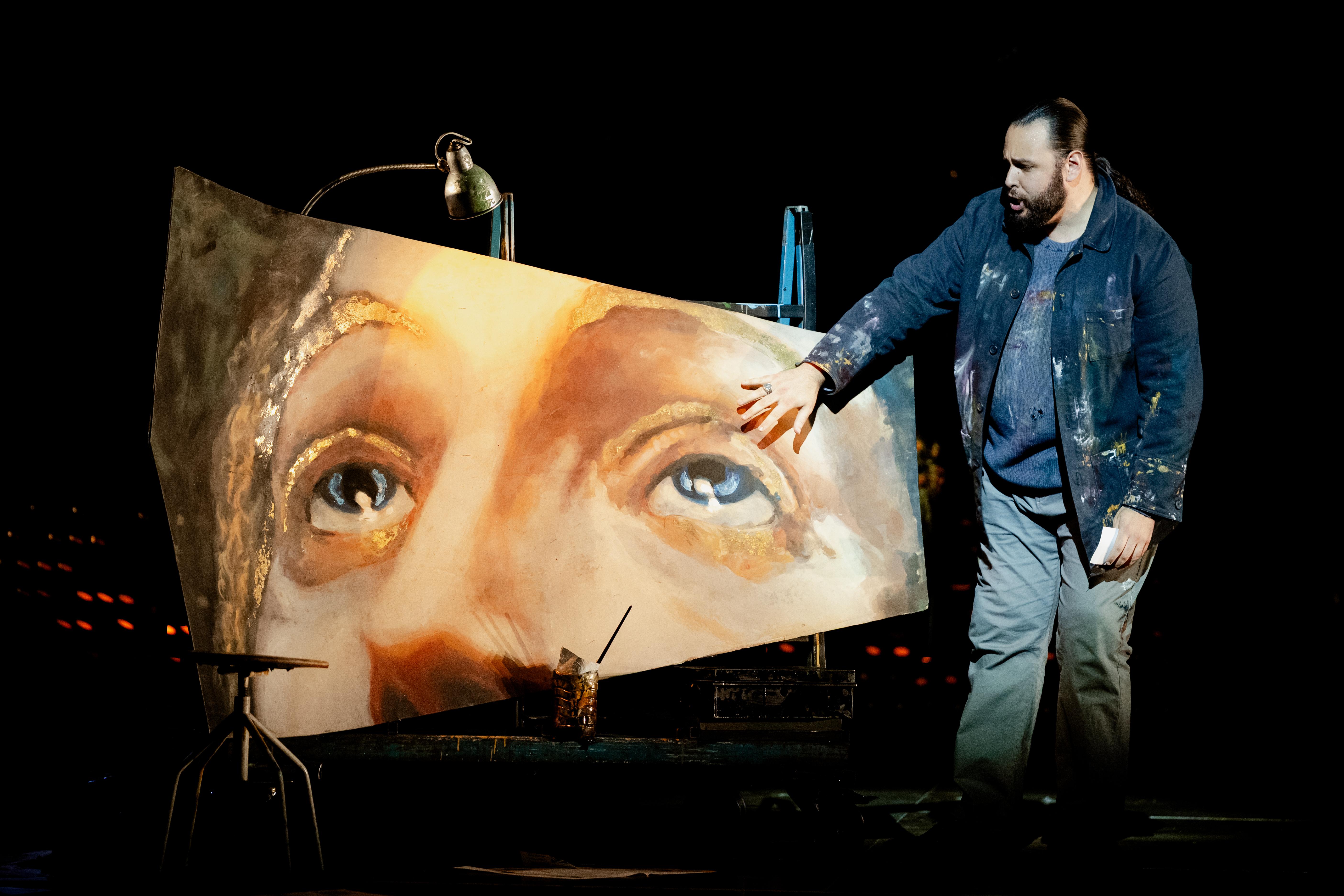 Main stood next to a large image of a persons head
