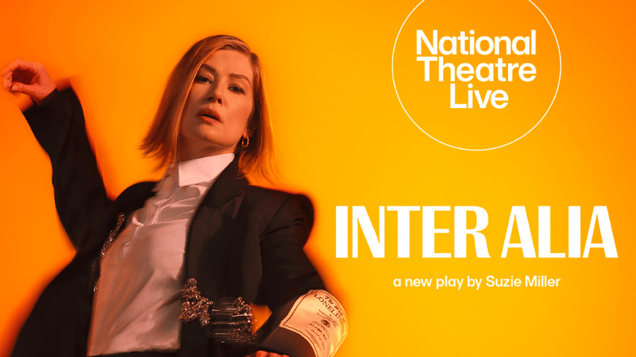 a middle aged woman with a blonde bob, wearing a black jacket and white shirt, stands dramatically with her arms spread. Behind her a yellow/orange background and the words INTER ALIA 