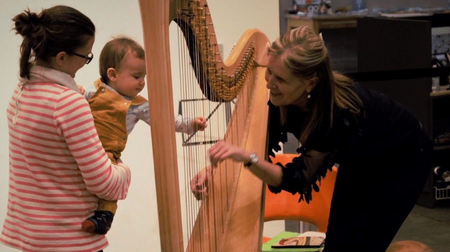 image of baby trying to play the harp