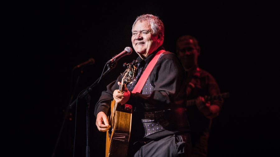 image of man holding a guitar