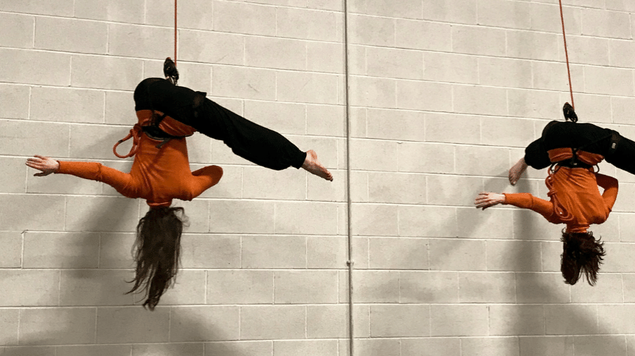 two people hanging from ropes