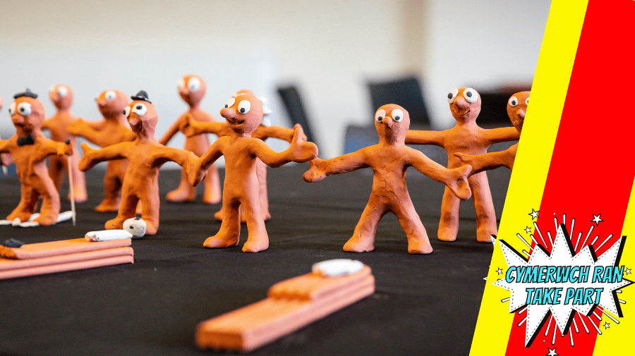 a table full of tiny brown figures made of clay 