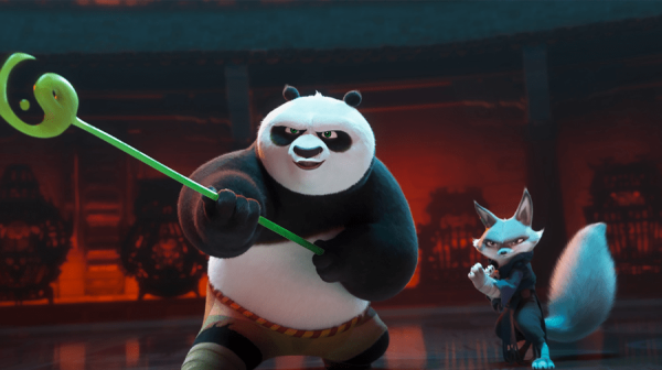 Po the Panda stands in an attack pose. He's holding a long green pole with the yin and yang symbol on the end of it 
