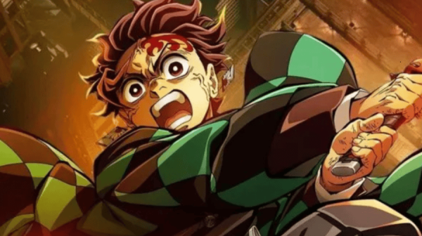 a manga/anime style image, of a character with brown hair and a blood-smeared forehead. They are screaming, open mouthed, and seem to be wielding a sword. They are wearing a green cloak 