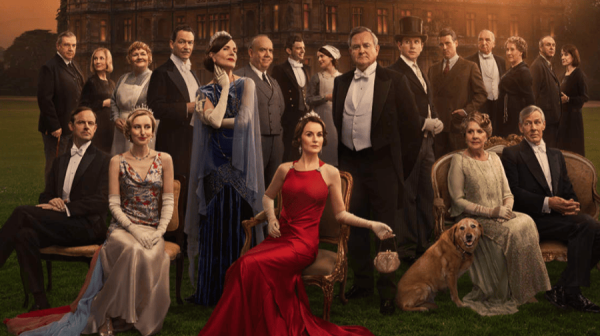 a large group photograph of all of the characters in Downton Abbey in either evening wear or work wear of the period 