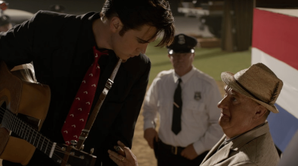 image of elvis leaning in to the colonel