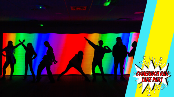 image of people dancing in front of rainbow lights